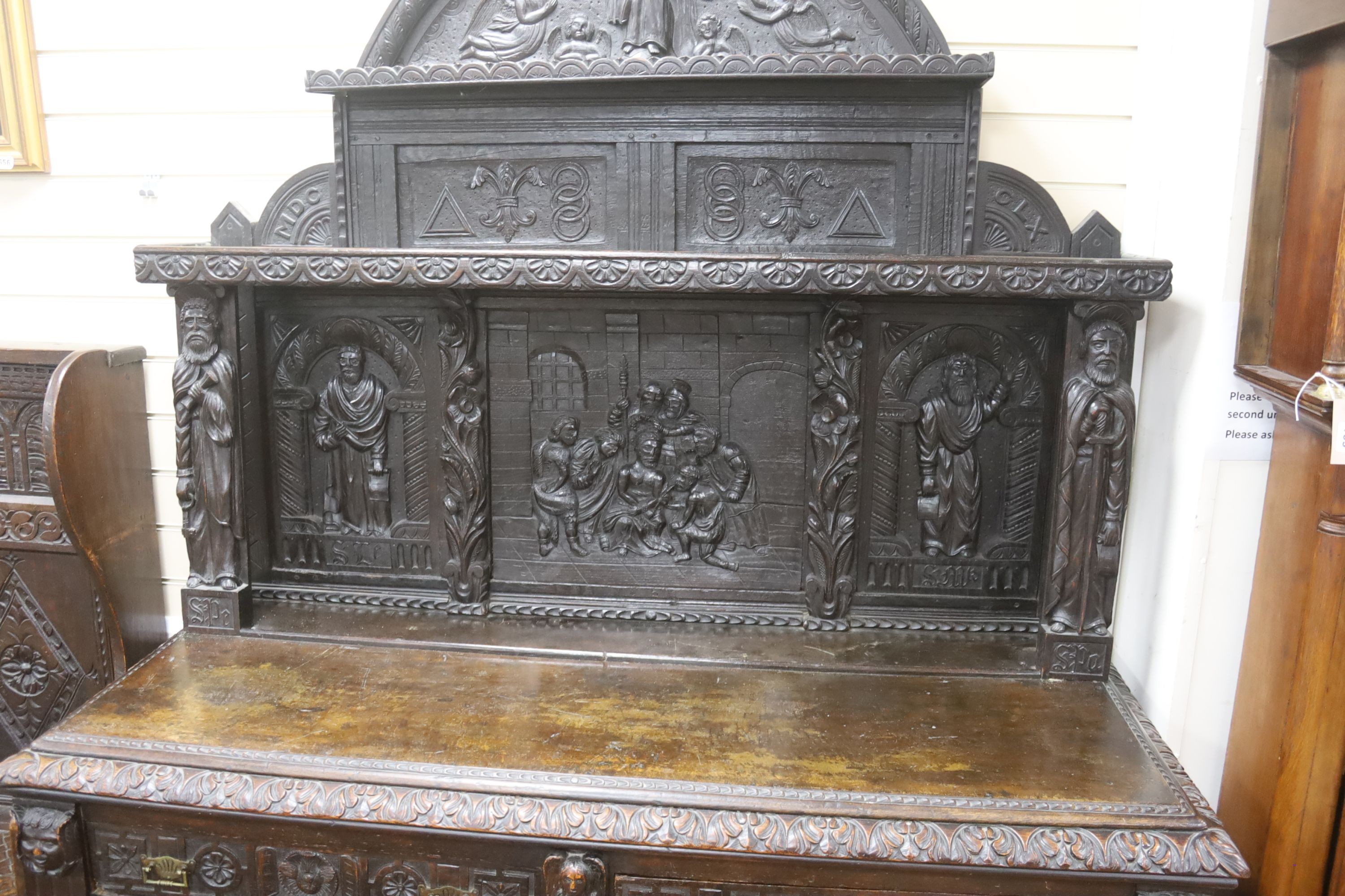 A late 19th century Flemish carved oak sideboard with raised panelled back, width 150, depth 60, height 215 cms.
